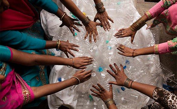 womens hands on plastic bottles